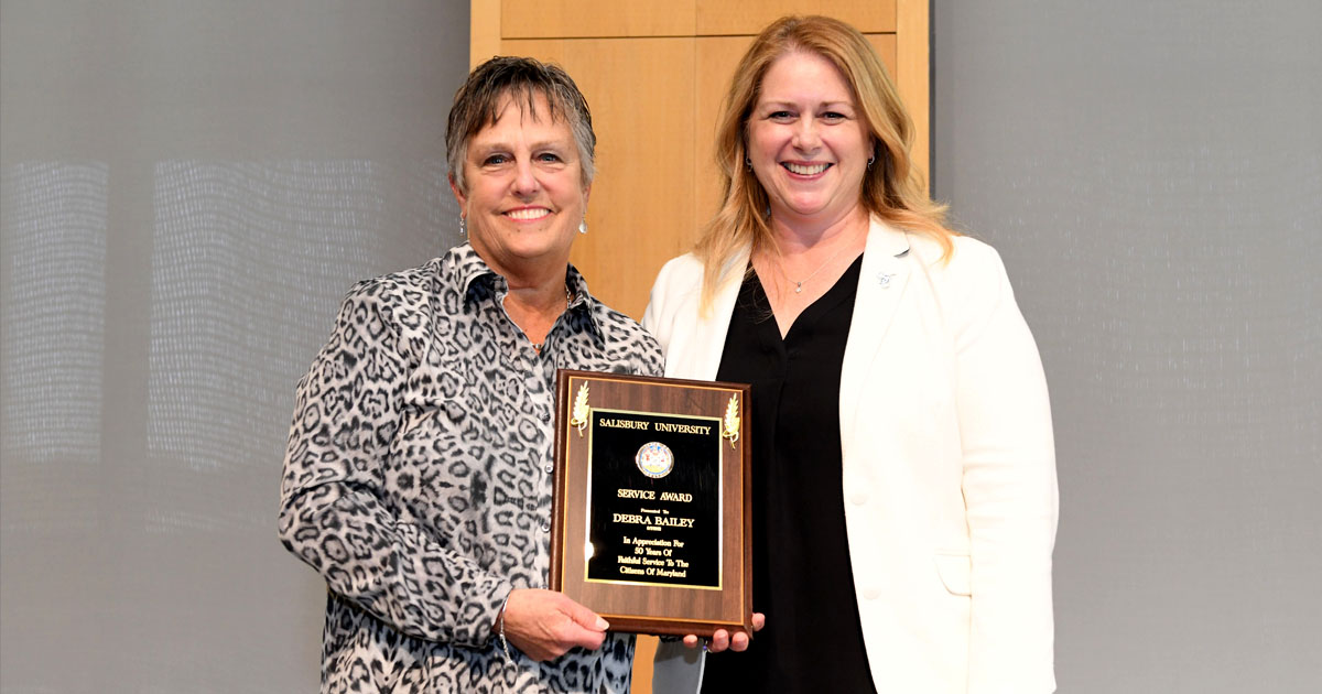 Debra Bailey, left, receives her 50-year Service Award from SU President Carolyn Ringer Lepre.